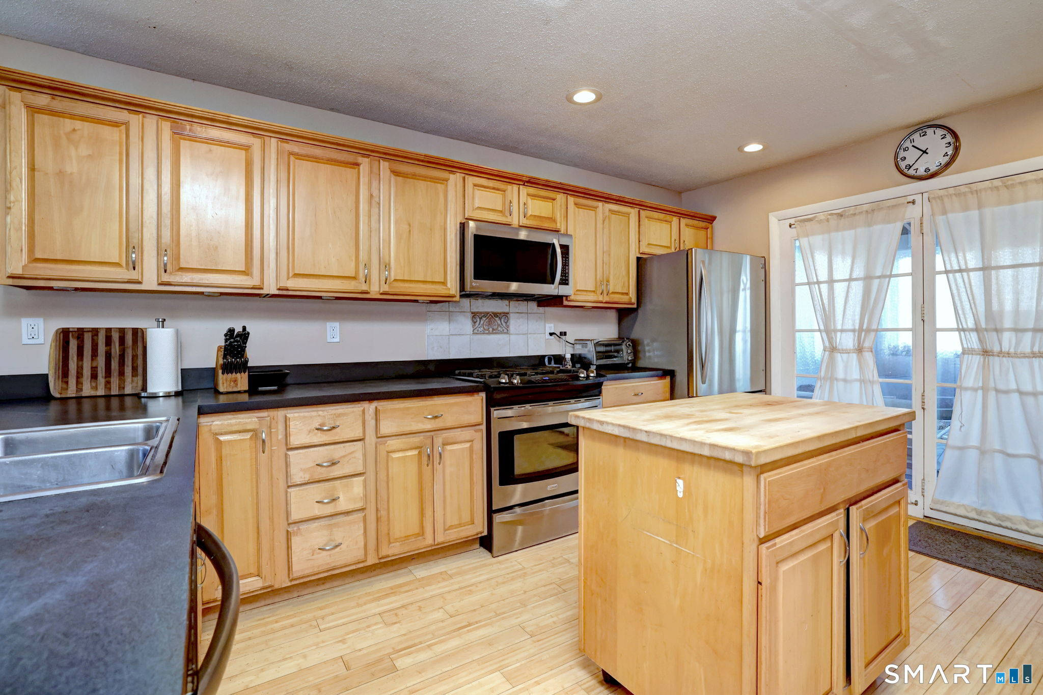 67 Hauser Street Milford, CT 06460 - Photo 15 of 40 a kitchen with stainless steel appliances granite countertop a stove a sink and a refrigerator