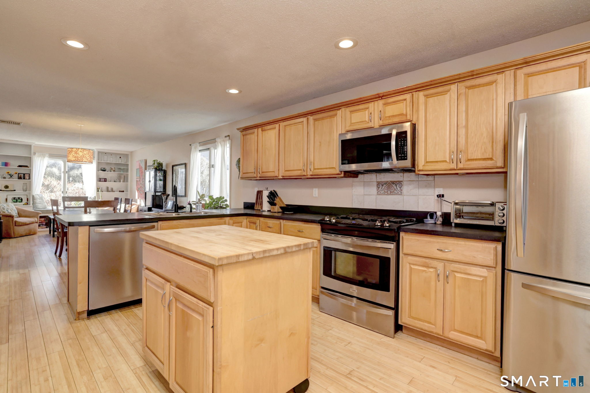 67 Hauser Street Milford, CT 06460 - Photo 16 of 40 a kitchen with stainless steel appliances granite countertop a stove a sink and a refrigerator