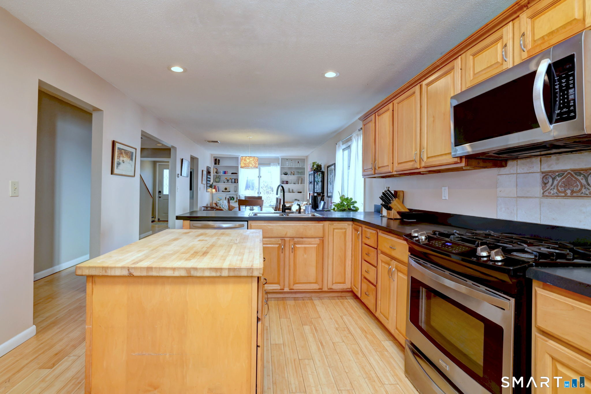 67 Hauser Street Milford, CT 06460 - Photo 17 of 40 a kitchen with stainless steel appliances a stove a microwave and cabinets