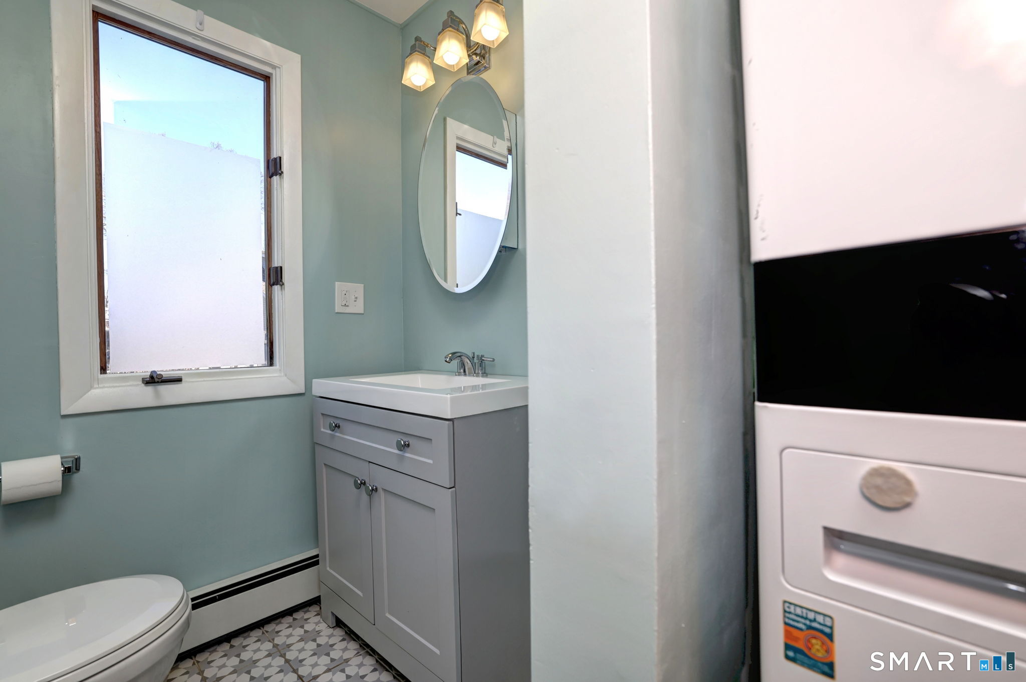 67 Hauser Street Milford, CT 06460 - Photo 18 of 40 a bathroom with a sink a toilet and a mirror