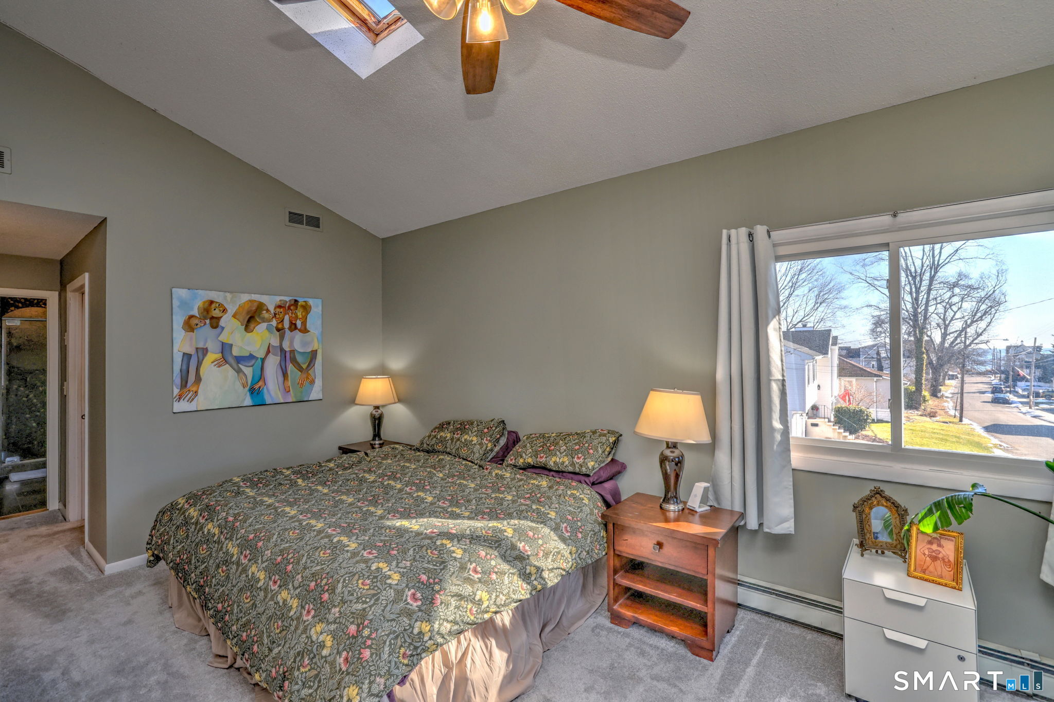 67 Hauser Street Milford, CT 06460 - Photo 20 of 40 a bedroom with a bed and a lamp next to a window