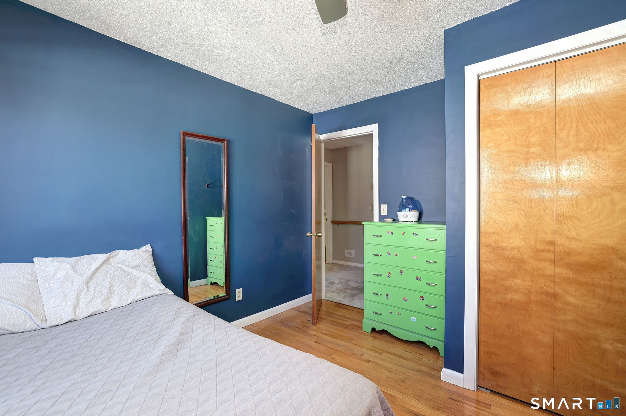 67 Hauser Street Milford, CT 06460 - Photo 32 of 40 a bedroom with a bed and a mirror