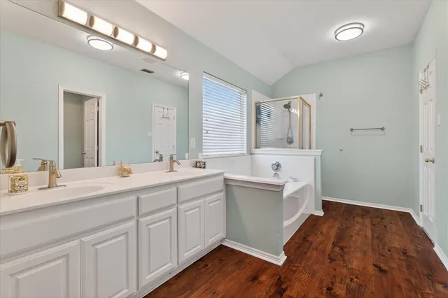a spacious bathroom with a sink mirror and a bathtub