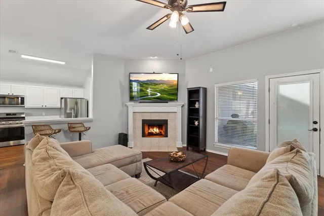 a living room with furniture a fireplace and a flat screen tv