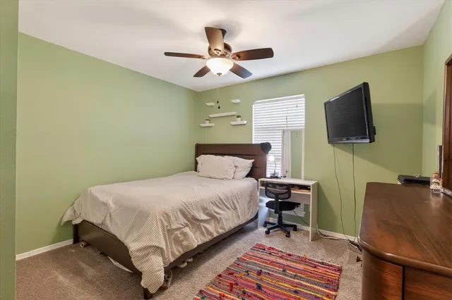 a bedroom with a bed and flat screen tv