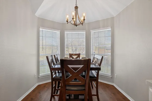 a view of a dining room with furniture and window