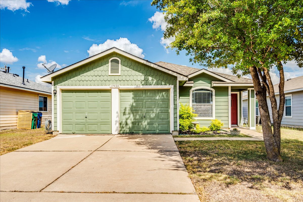 a front view of a house with a yard and outdoor seating