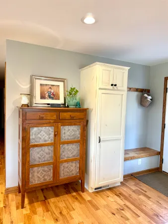 a view of a hallway with closet and window