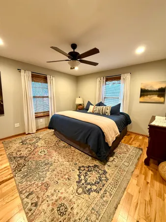 a bedroom with a large bed and a chandelier
