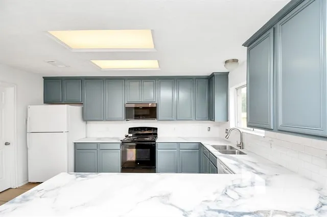 a kitchen with a sink a stove and refrigerator