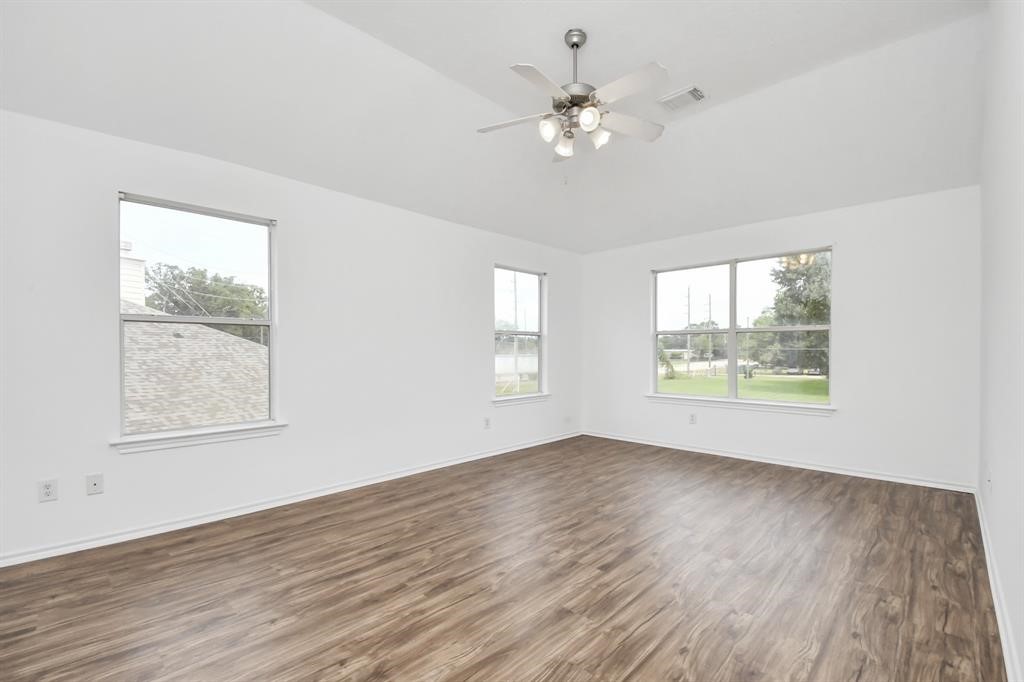 21818 Dimmett Way Spring, TX 77388 - Photo 19 of 35 a view of an empty room with wooden floor and a window