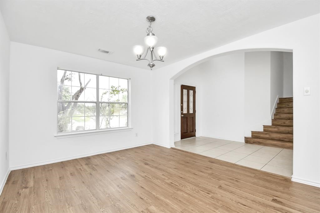 21818 Dimmett Way Spring, TX 77388 - Photo 20 of 35 a view of an empty room with wooden floor and a window
