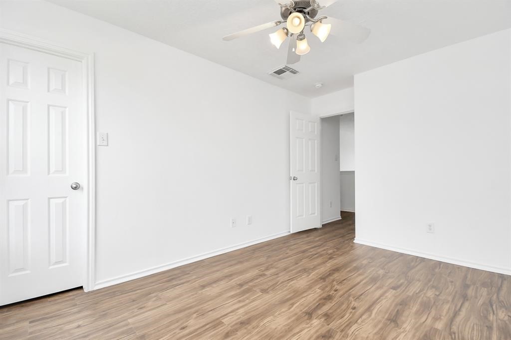 21818 Dimmett Way Spring, TX 77388 - Photo 23 of 35 an empty room with wooden floor and chandelier fan