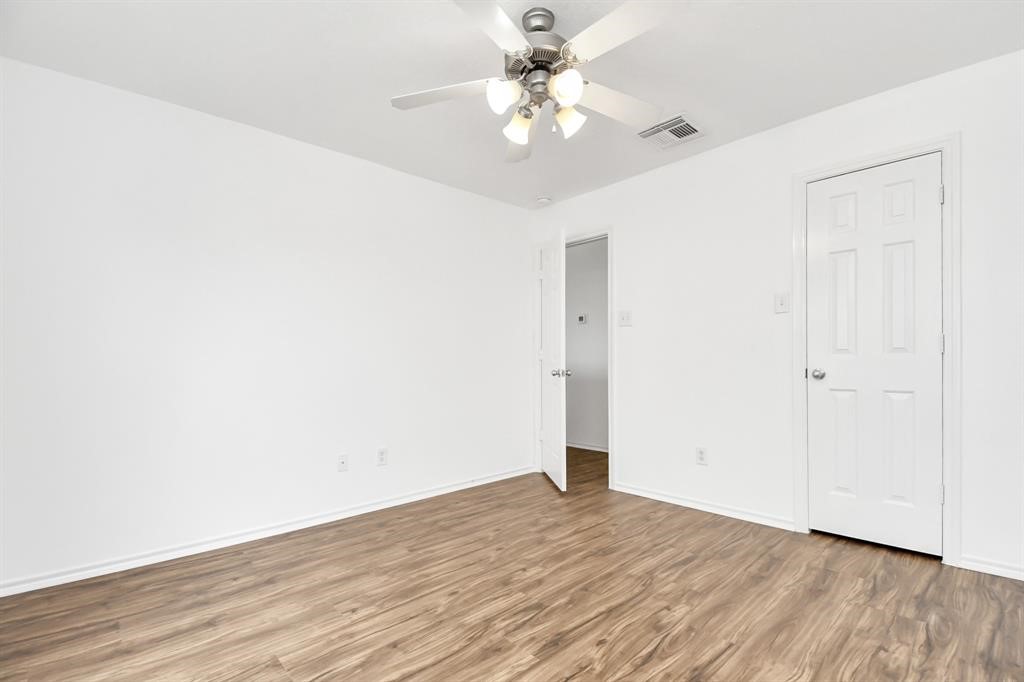 21818 Dimmett Way Spring, TX 77388 - Photo 24 of 35 a view of a room with wooden floor and a ceiling fan