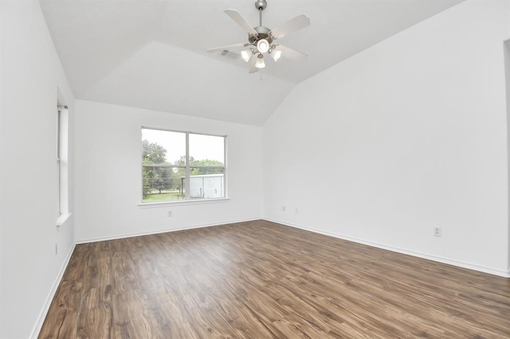 21818 Dimmett Way Spring, TX 77388 - Photo 25 of 35 an empty room with wooden floor and windows