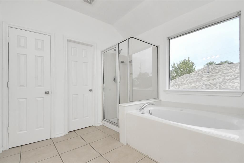 21818 Dimmett Way Spring, TX 77388 - Photo 28 of 35 a bathroom with a bathtub and shower