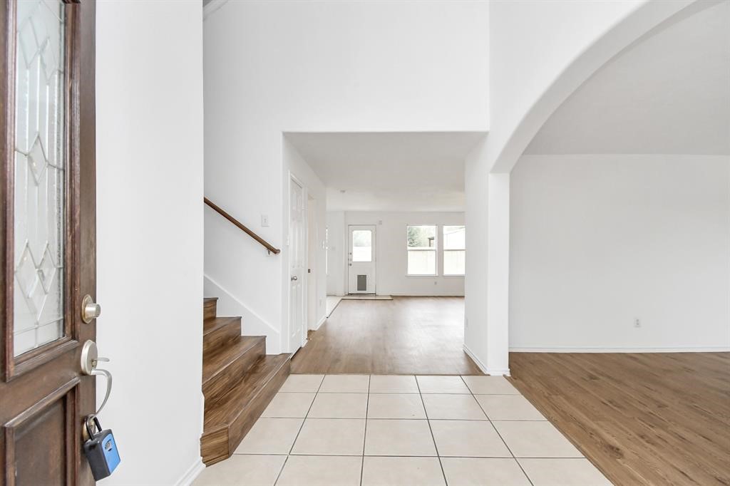 21818 Dimmett Way Spring, TX 77388 - Photo 3 of 35 a view of a hallway with a white walls and a window