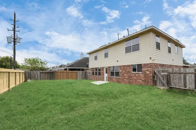 a view of a house with a yard and sitting area