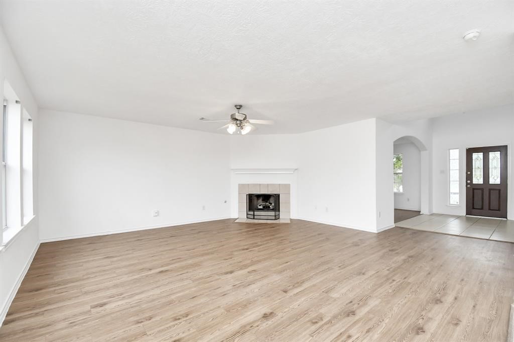 21818 Dimmett Way Spring, TX 77388 - Photo 5 of 35 wooden floor in an empty room with a window