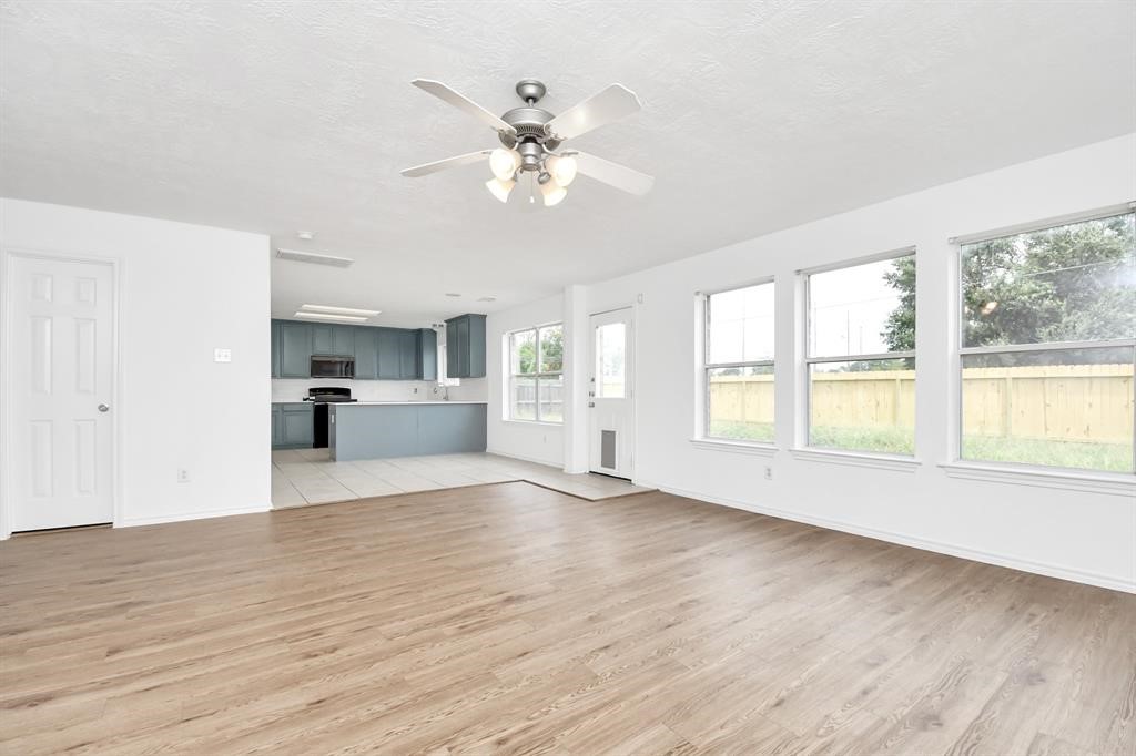 21818 Dimmett Way Spring, TX 77388 - Photo 7 of 35 a view of an empty room with a window and wooden floor