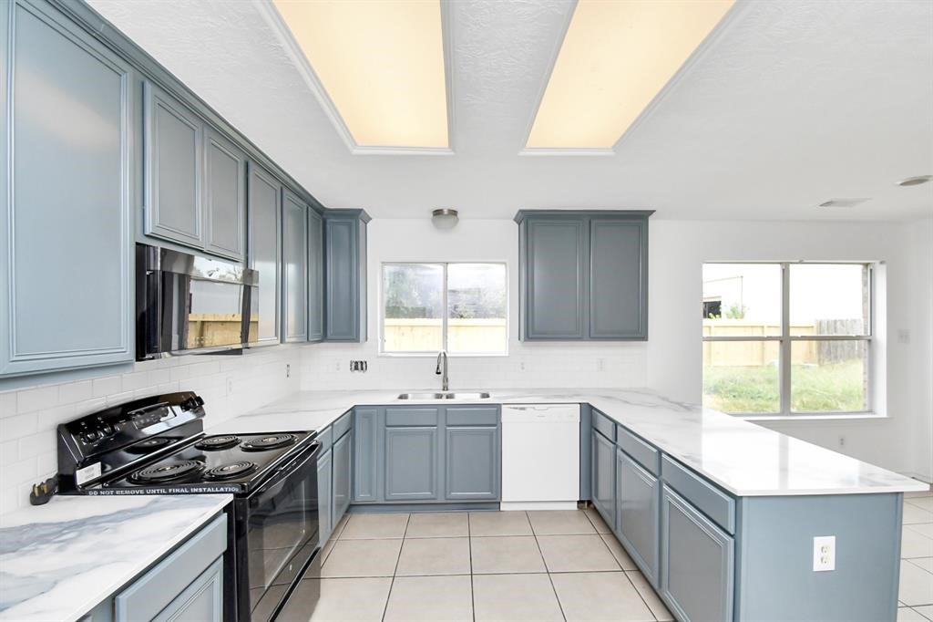 21818 Dimmett Way Spring, TX 77388 - Photo 8 of 35 a kitchen with a sink stove top oven and cabinets
