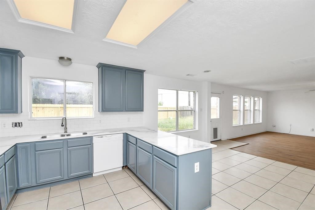 21818 Dimmett Way Spring, TX 77388 - Photo 9 of 35 a large white kitchen with a large window