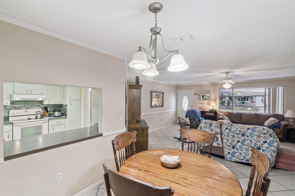 10943 Southwest 86th Court Ocala, FL 34481 - Photo 15 of 35 a view of a dining room with furniture and wooden floor