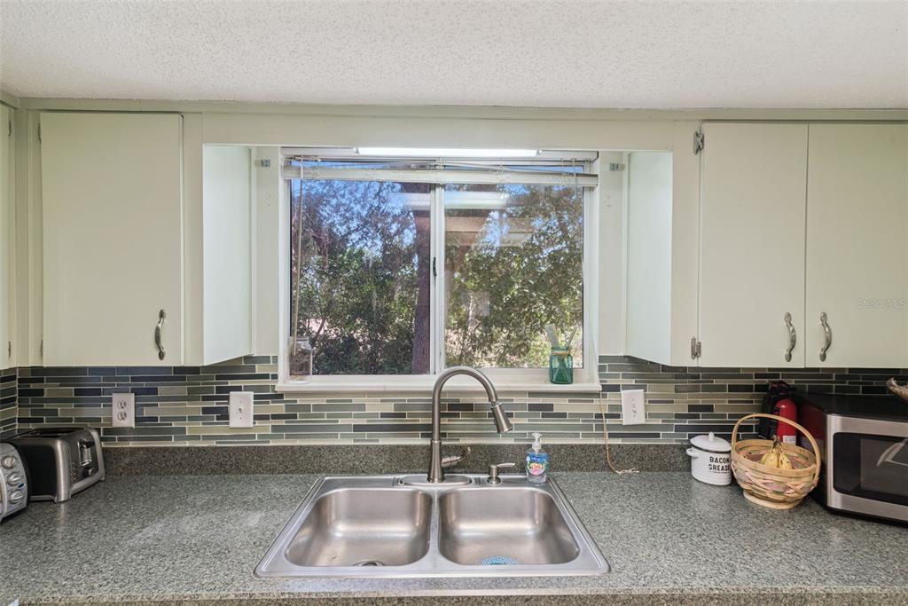 10943 Southwest 86th Court Ocala, FL 34481 - Photo 17 of 35 a kitchen with a sink and a stove top oven
