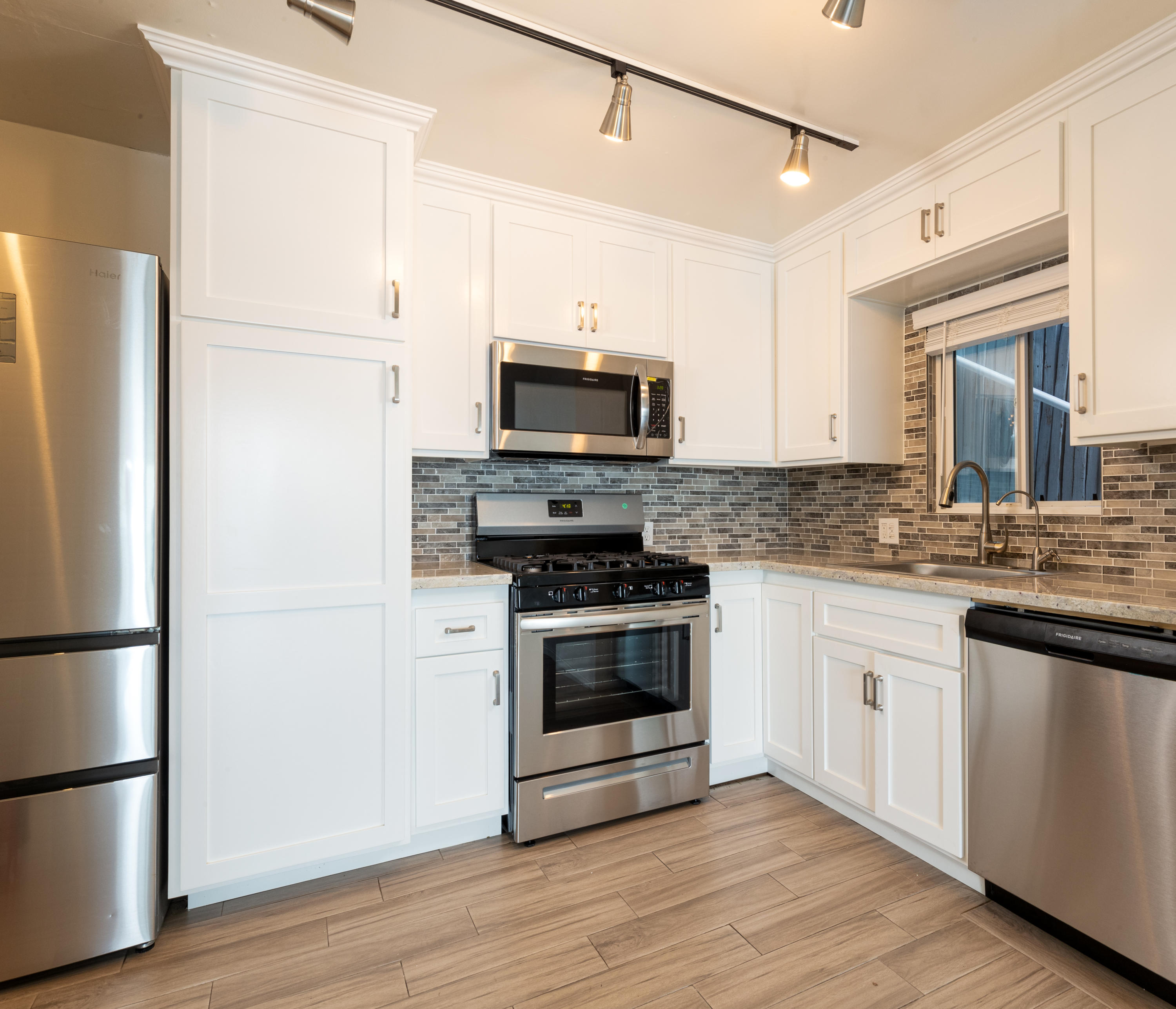 1520 Miramar Beach Montecito, CA 93108 - Photo 7 of 18 a kitchen with granite countertop a refrigerator and a stove top oven