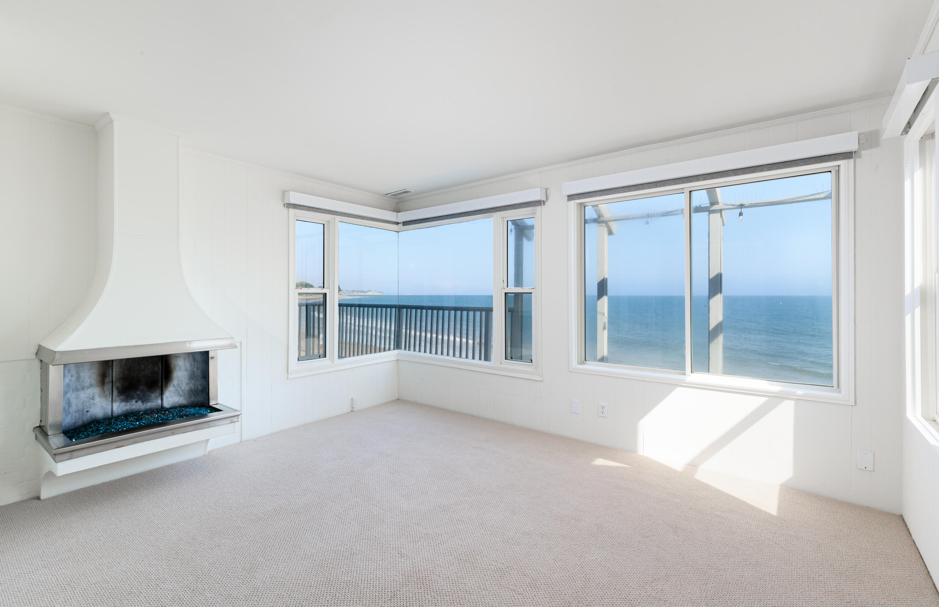 1520 Miramar Beach Montecito, CA 93108 - Photo 9 of 18 wooden floor fireplace and windows in an empty room