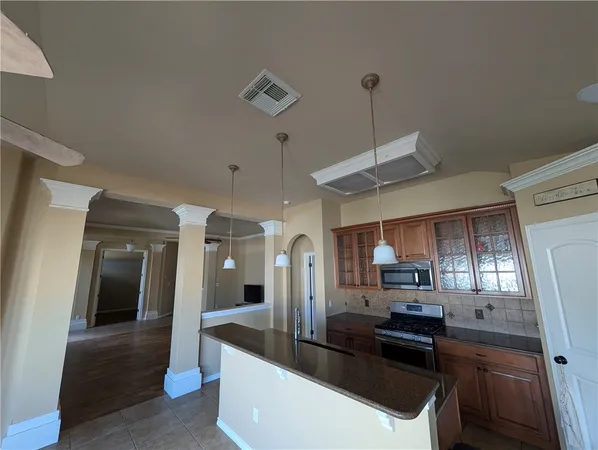 a kitchen with stainless steel appliances granite countertop a sink a stove and a refrigerator