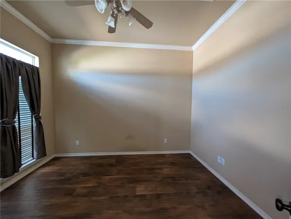 a view of a room with wooden floor