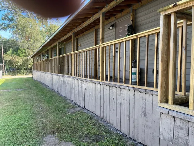 a view of a house with backyard and porch