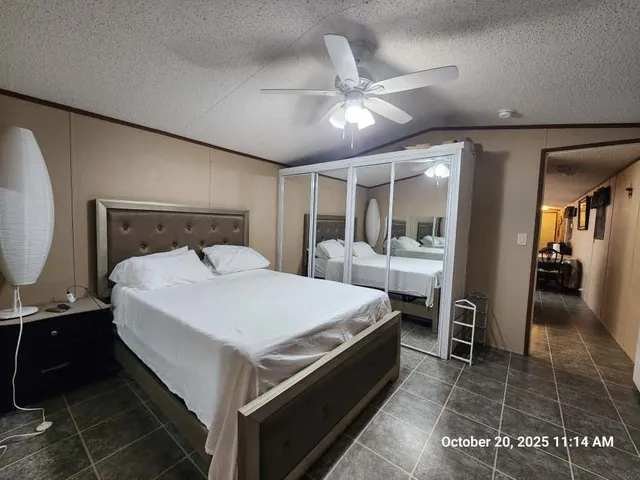 a bed room with a bed and mirror