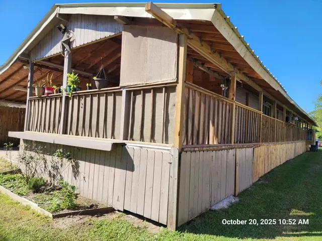 a view of a house with wooden fence