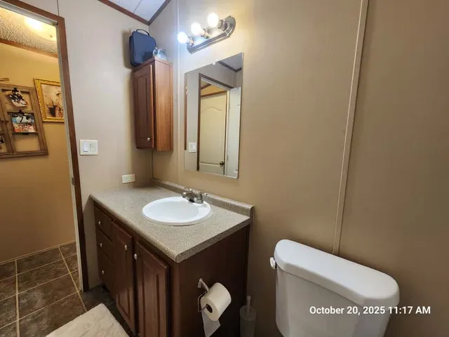 a bathroom with a toilet sink and mirror