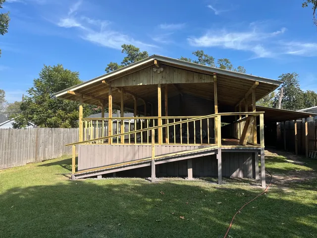 a view of a house with a yard and deck