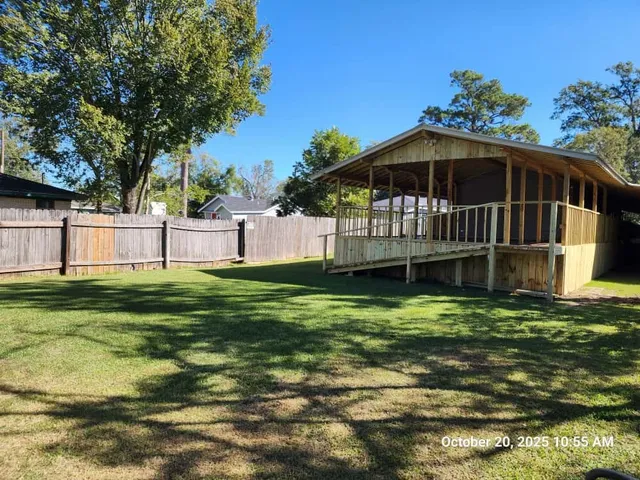 a view of a chair and table in the backyard