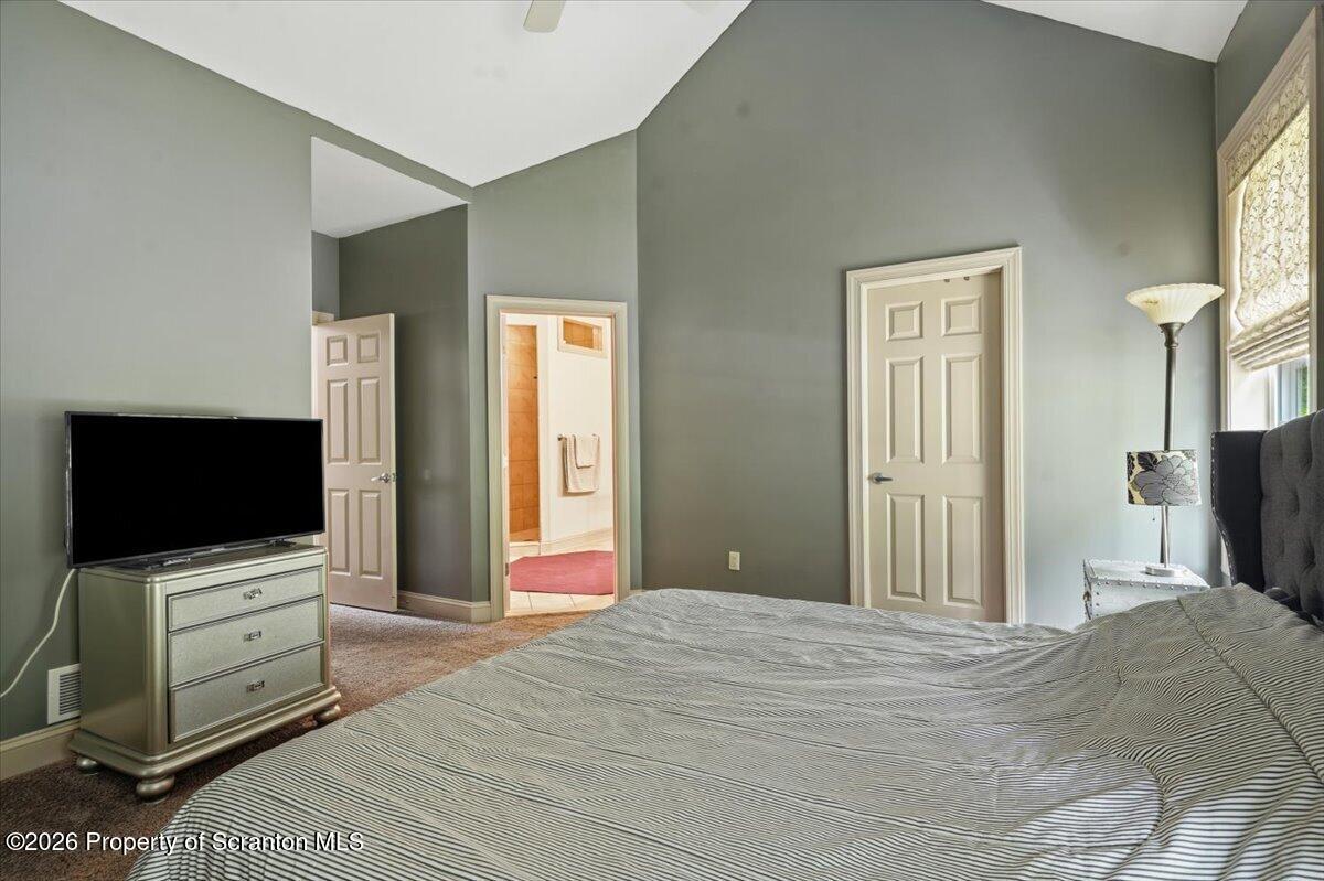 99 Hilltop Road Waverly, PA 18471 - Photo 27 of 41 a bedroom with a bed and a flat screen tv