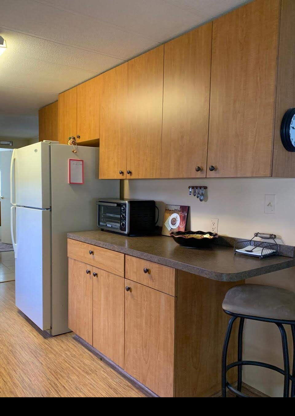 12 Orinco Road Fort Pierce, FL 34952 - Photo 19 of 50 a kitchen with stainless steel appliances kitchen island granite countertop a refrigerator a stove and a sink