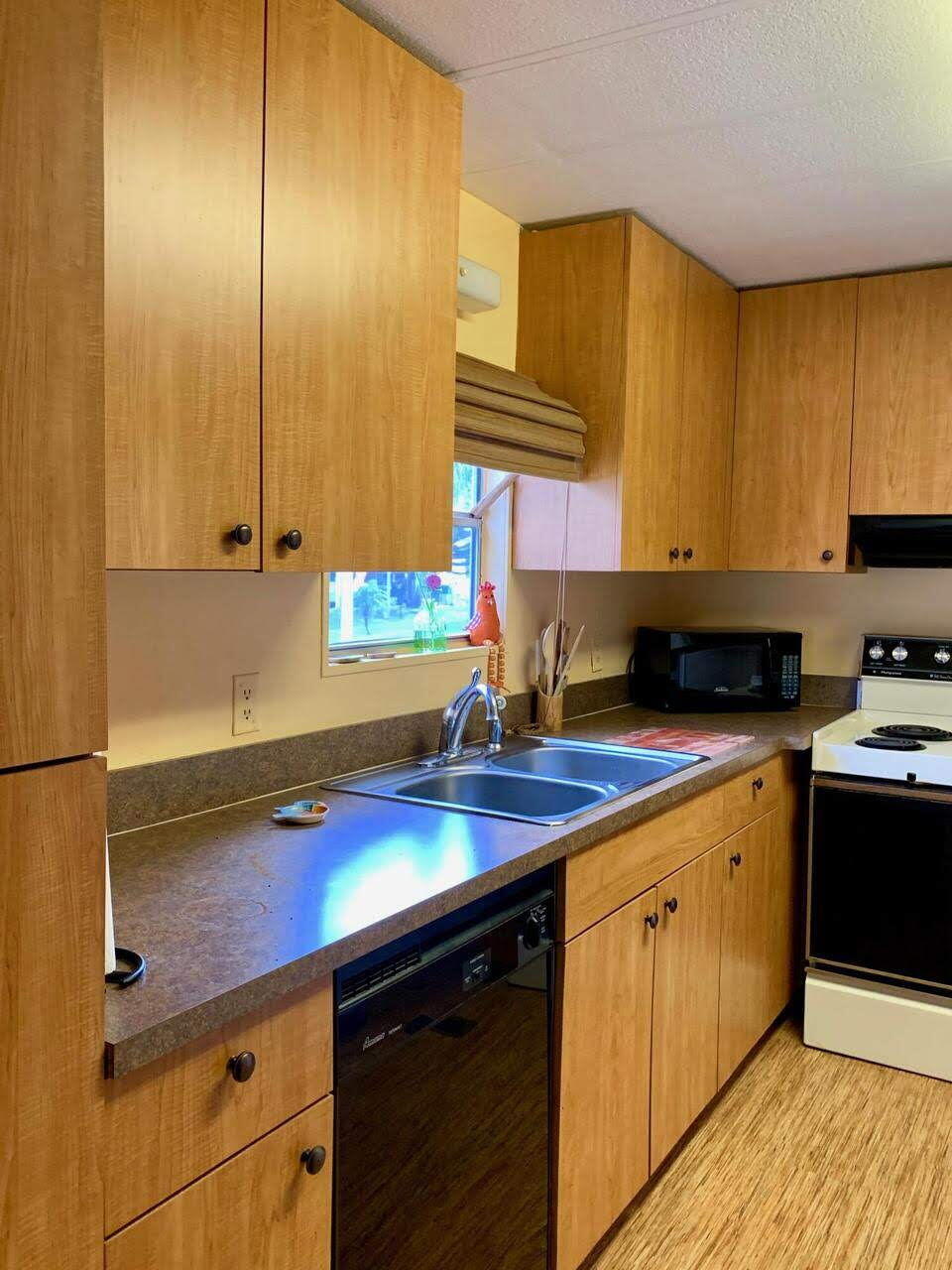12 Orinco Road Fort Pierce, FL 34952 - Photo 20 of 50 a kitchen with stainless steel appliances a sink dishwasher stove and cabinets