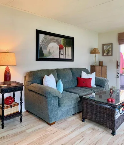 a bedroom with a bed and a potted plant on dresser