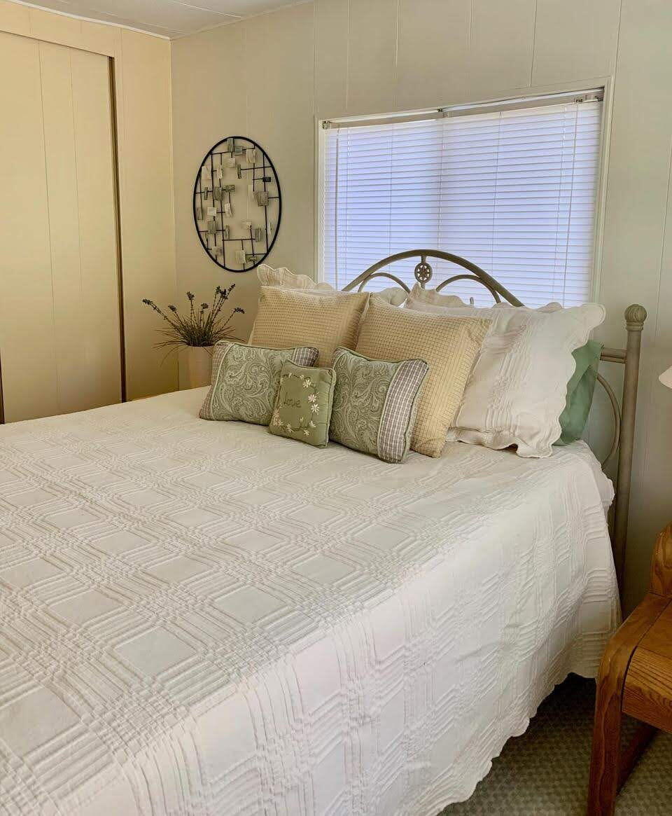 12 Orinco Road Fort Pierce, FL 34952 - Photo 40 of 50 a bedroom with a bed and a closet with wooden floor