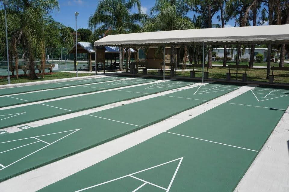 12 Orinco Road Fort Pierce, FL 34952 - Photo 4 of 50 a view of a tennis ground with large trees
