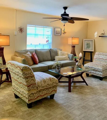 a view of a dining room with furniture and a chandelier