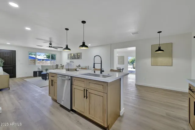 a kitchen with sink cabinets and wooden floor