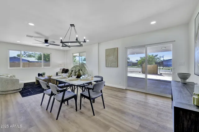 a view of a dining room with furniture wooden floor and chandelier