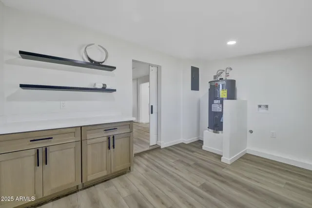 a view of a kitchen with wooden floor and cabinets