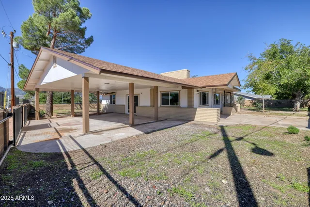 a view of a house with backyard porch and sitting area
