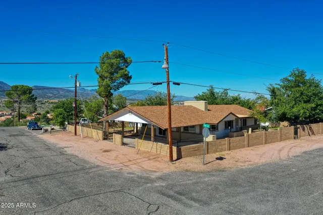 an aerial view of a house with swimming pool and glass top table and chairs